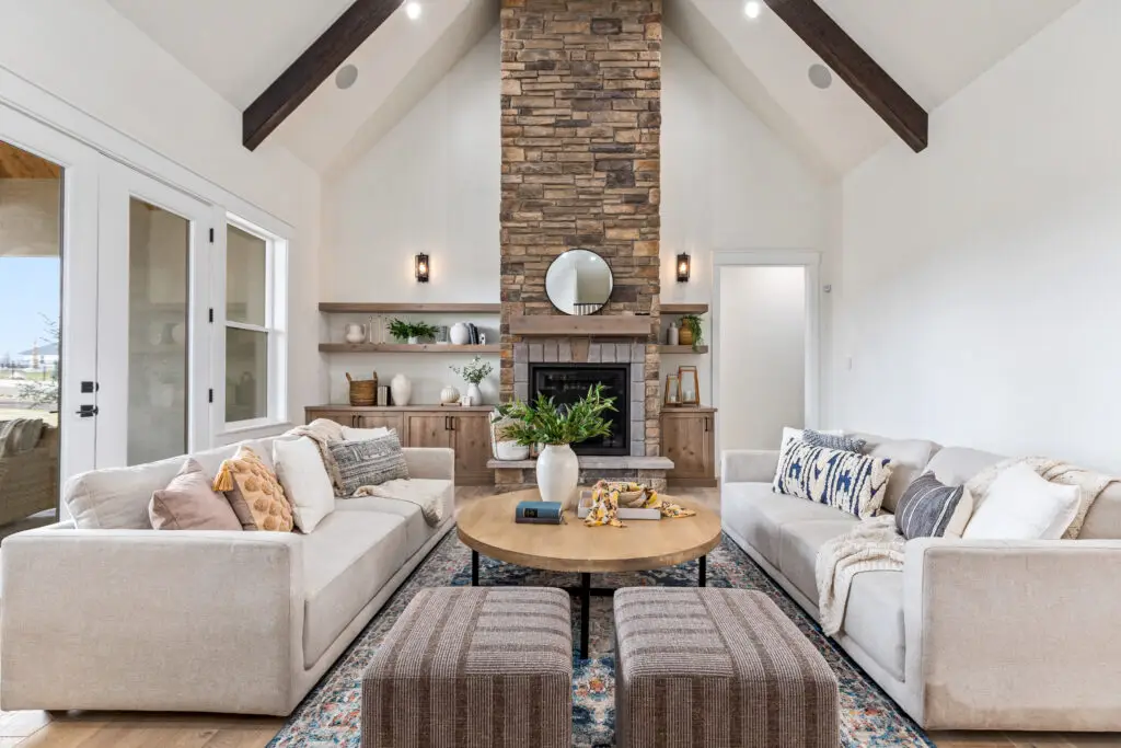 Stone fireplace and living room at Bur Oak Place, a luxury home by Pleasant View