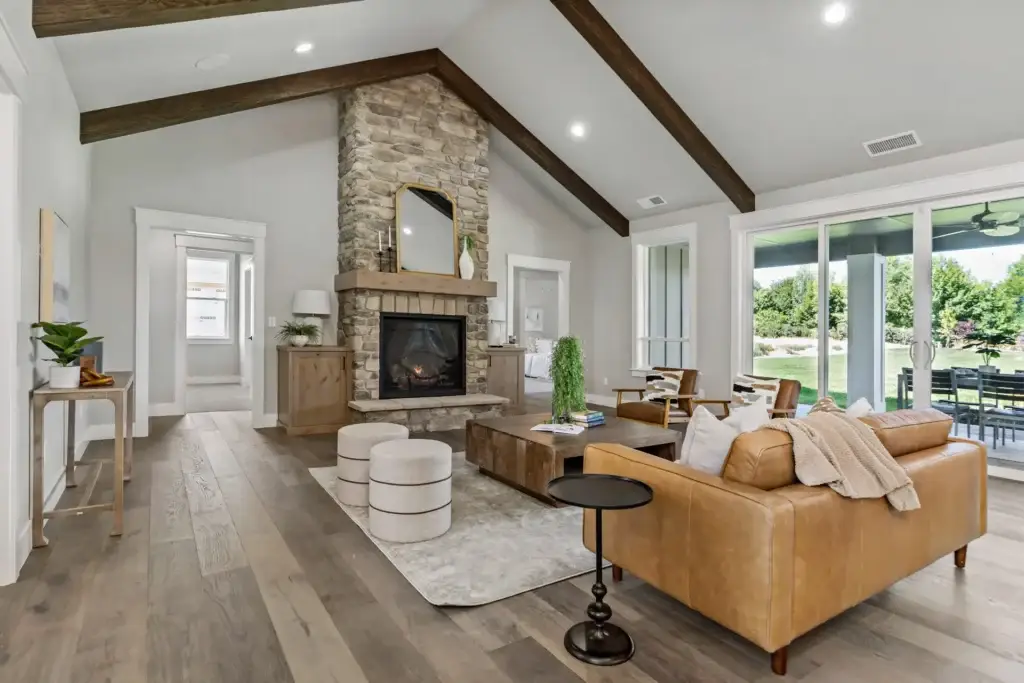 Luxury living room with a stone fireplace and exposed beams