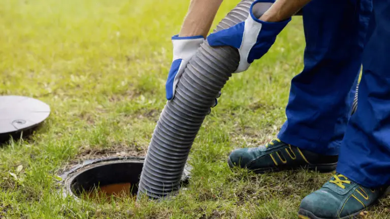 Septic system expert pumping out a tank