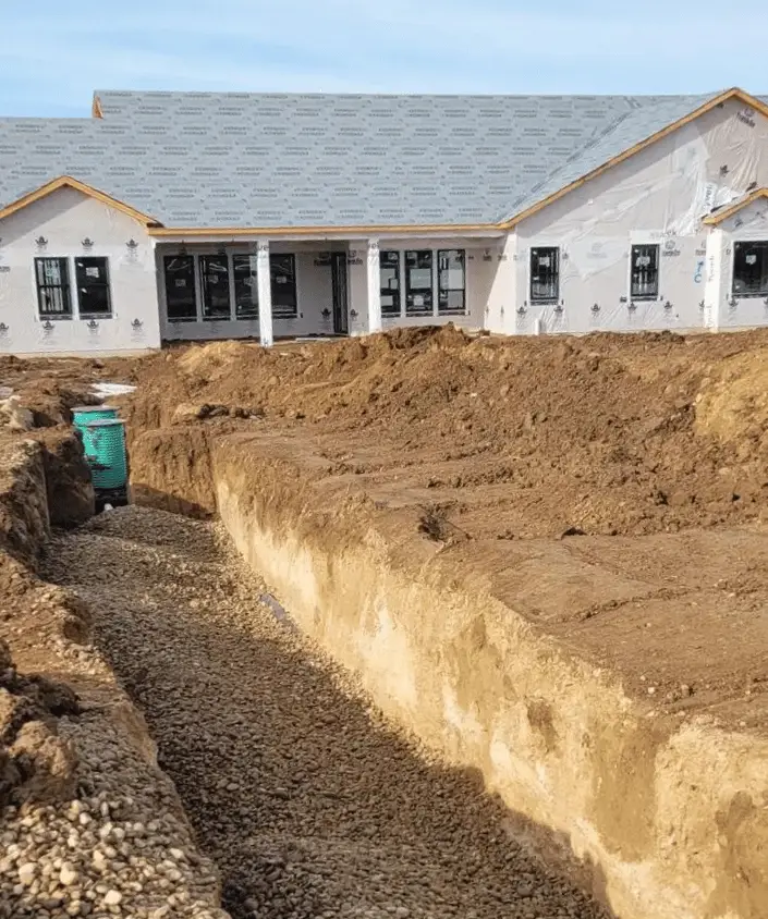 New home with a trench for a new septic tank installation