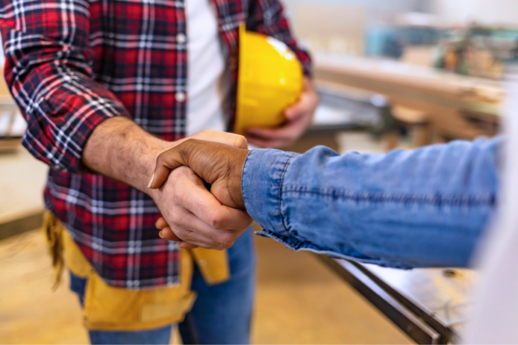 General contractor shaking a client's hand