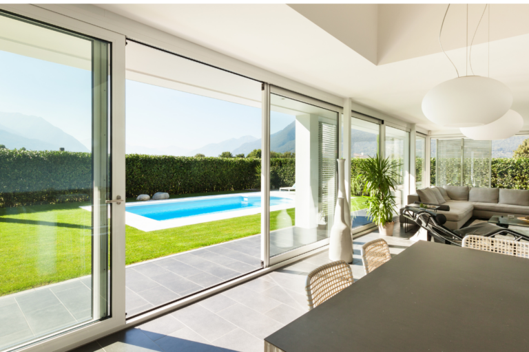 Sliding glass door leading to a backyard and pool