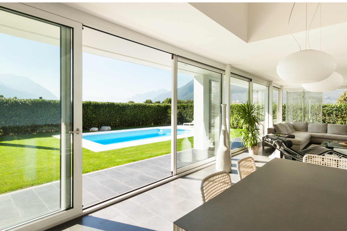 Sliding glass door leading to a backyard and pool